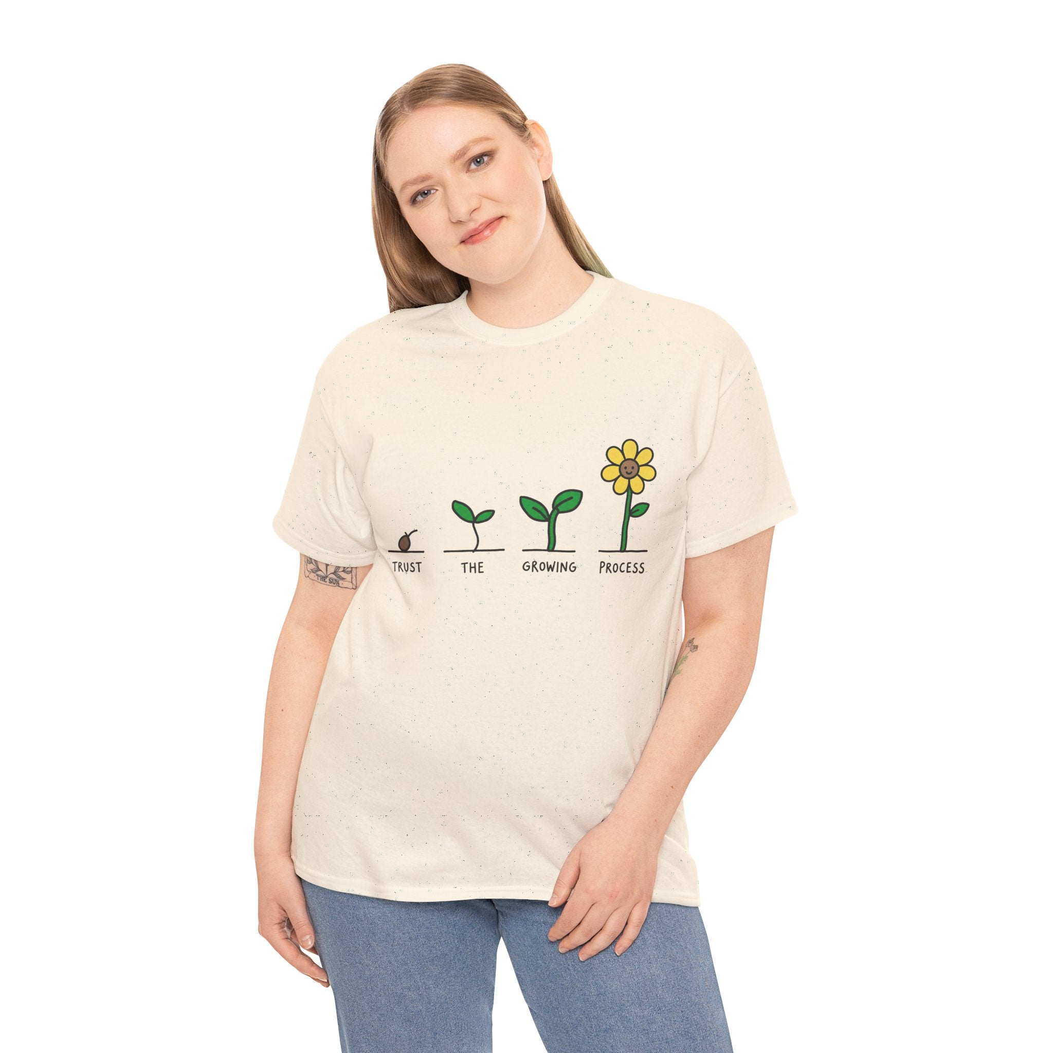 Natural/off-white crewneck T-shirt on model, seedling-to-flower graphic in green and yellow