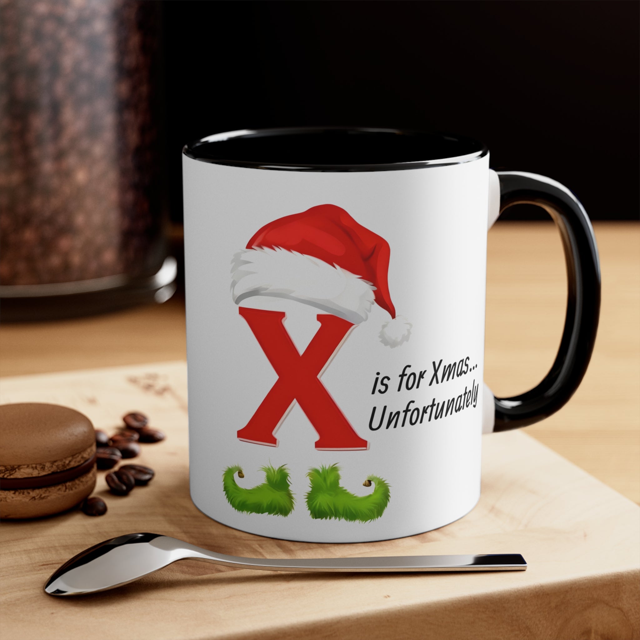 Black coffee mug with red letter X, Santa hat and green holly; printed holiday text