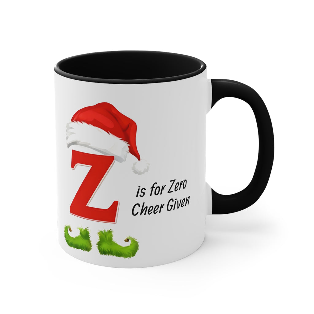 White mug with black handle, letter Z with Santa hat and “is for Zero Cheer Given”