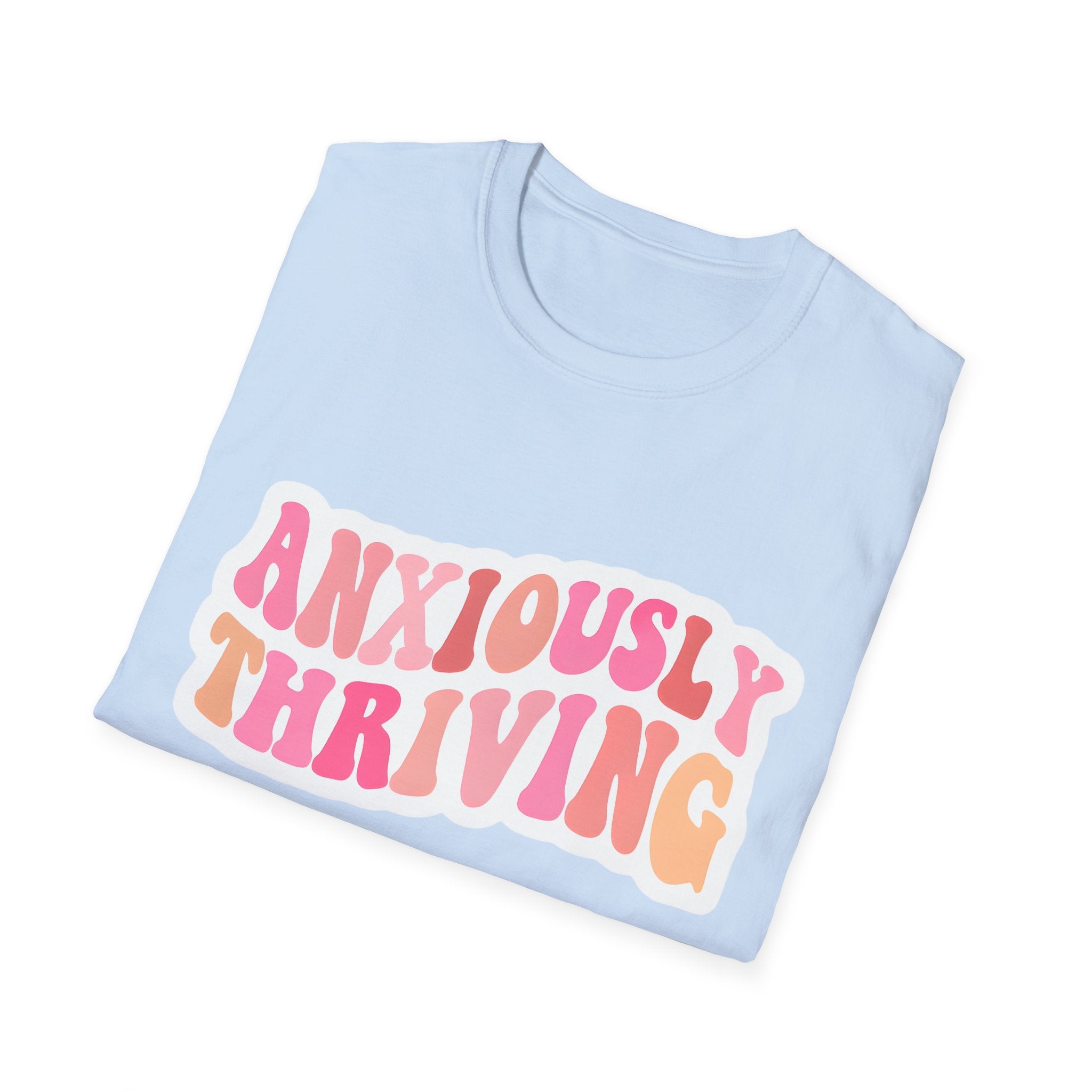 Unisex softstyle t-shirt light blue with “ANXIOUSLY THRIVING” graphic on chest