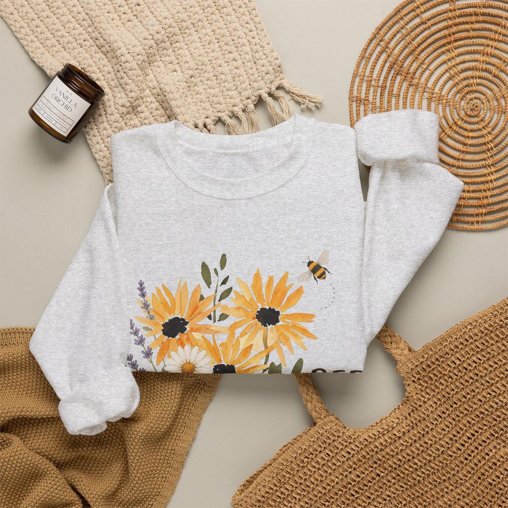 Gray crewneck sweatshirt with sunflower bouquet graphic and partial 'BEE' lettering.