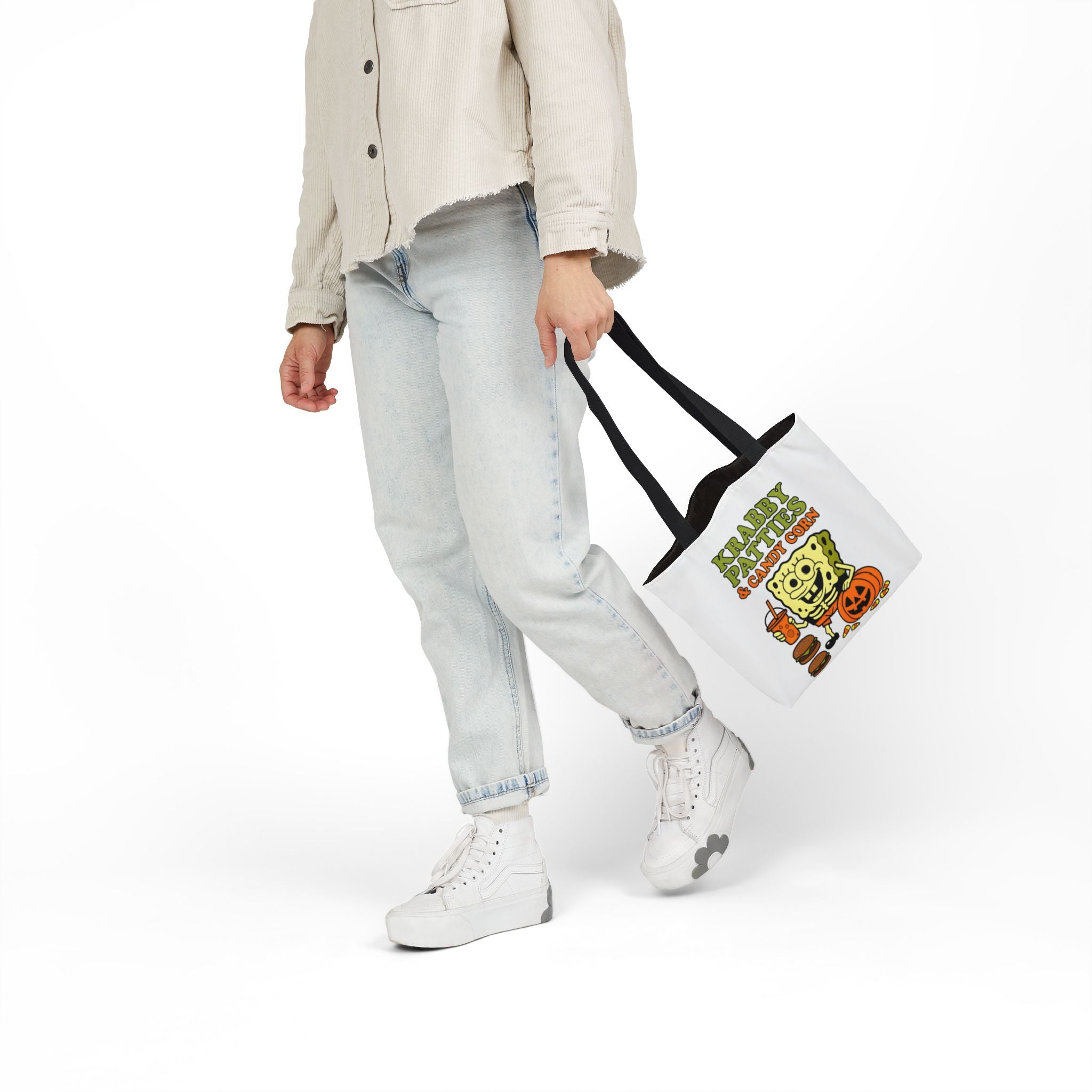 White canvas tote bag with black handles and Krabby Patties & candy corn print, side view