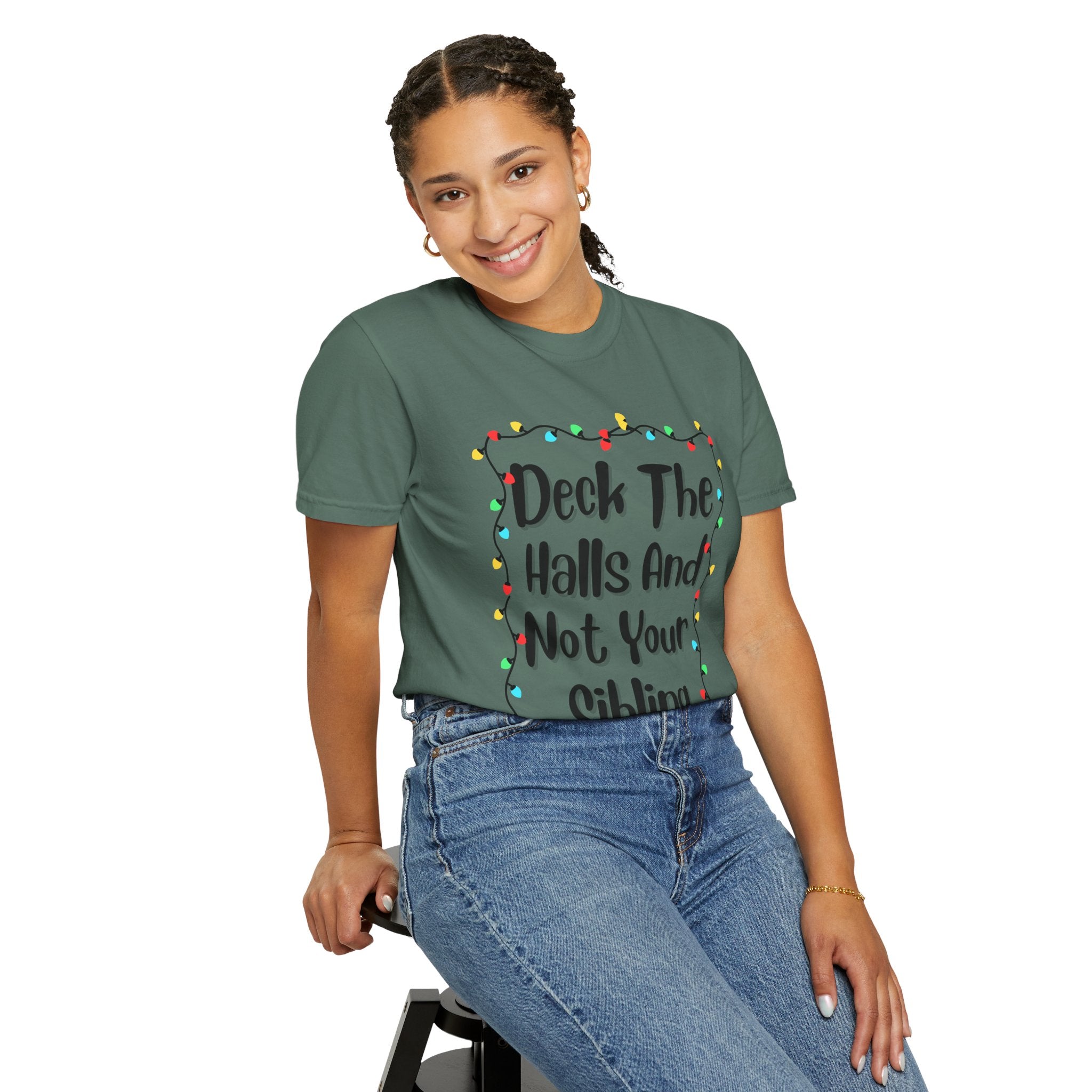 Sage green T-shirt with 'Deck The Halls And Not Your Sibling' and multicolor lights graphic