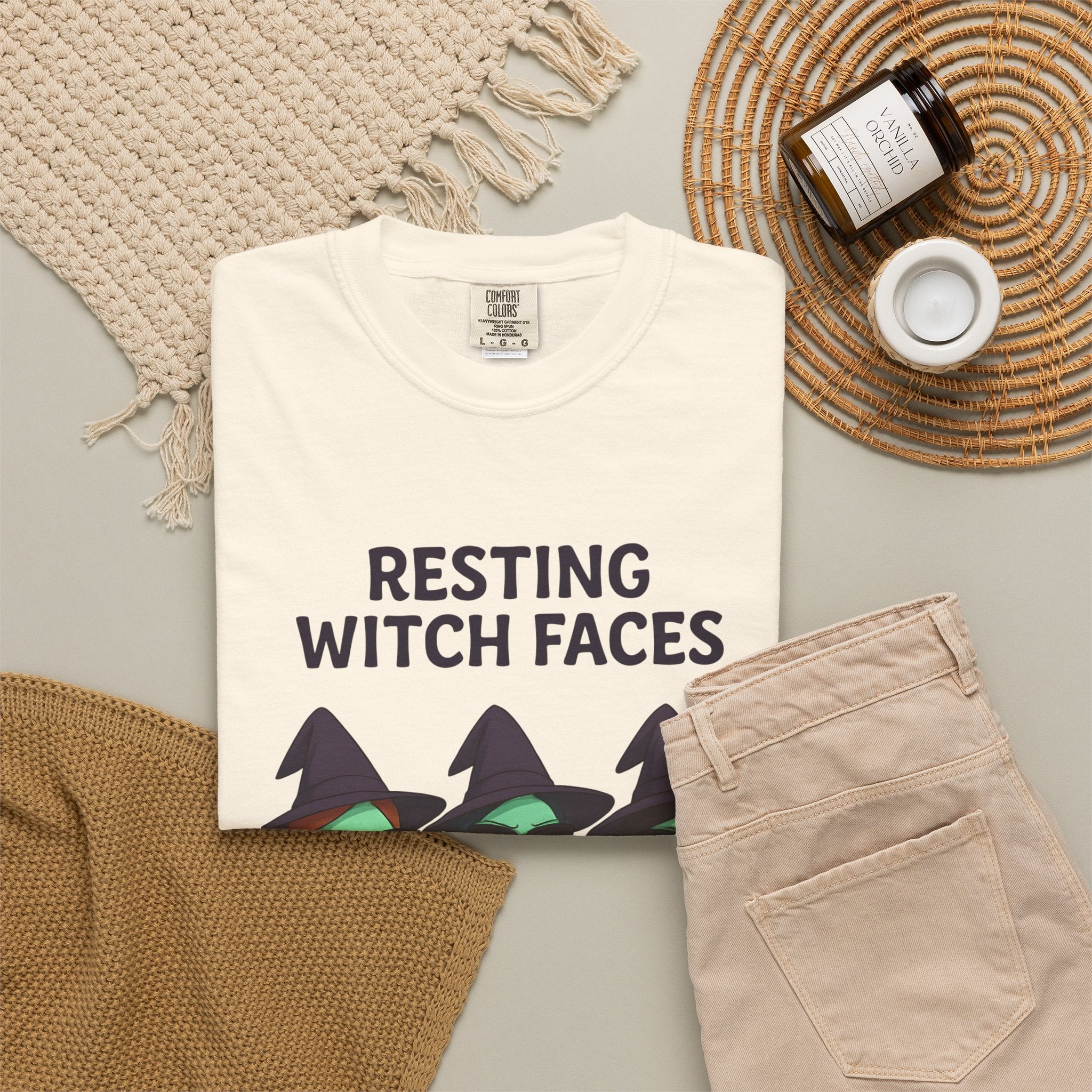 White crew-neck graphic T-shirt, front witch faces print