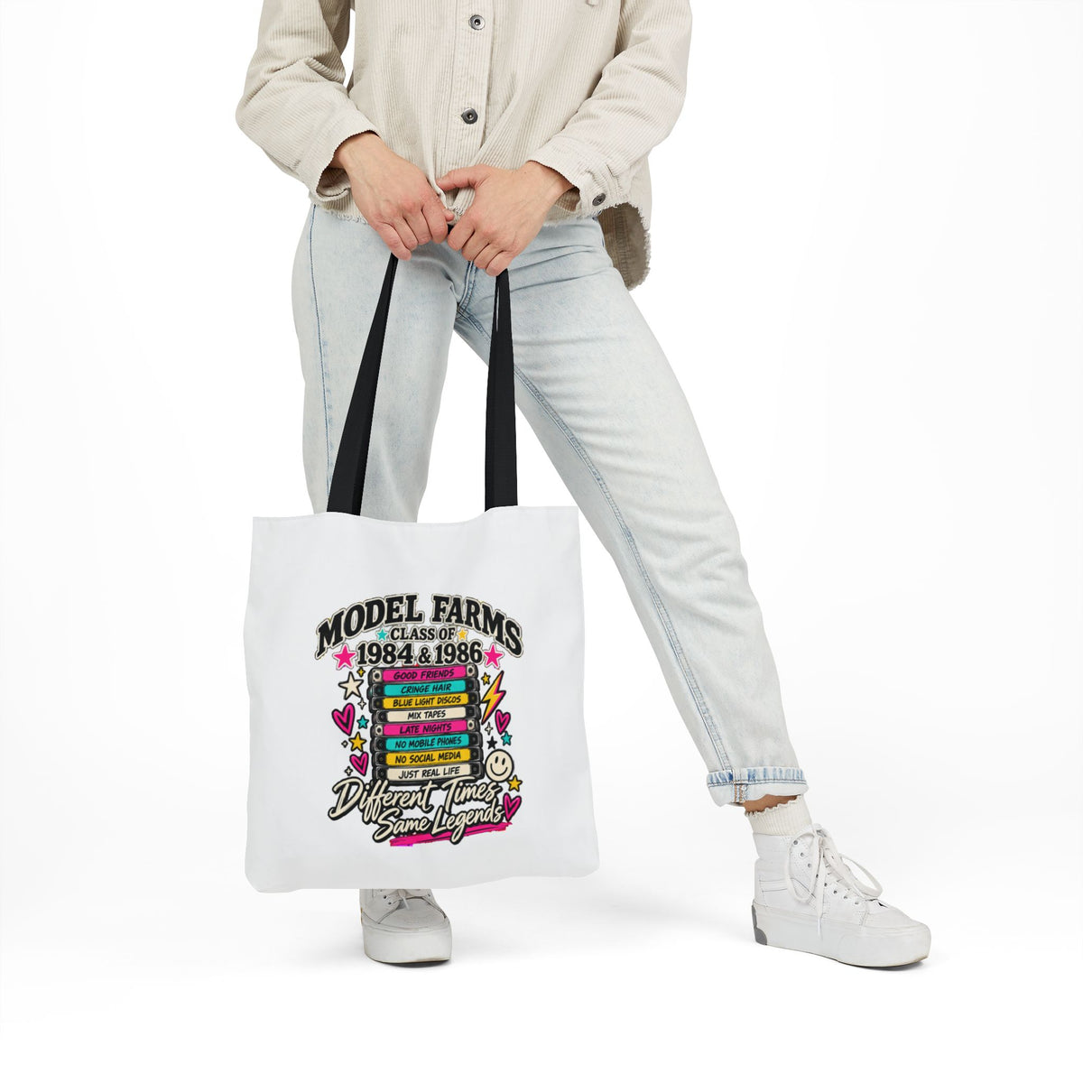 White canvas tote bag with black handles and colorful retro graduation graphic front