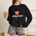 Black crewneck sweatshirt with red-and-white lollipop heart graphic and text