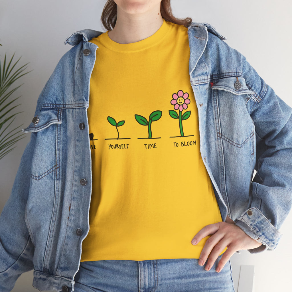 Yellow T-shirt with green sprout-and-flower growth graphic and message text
