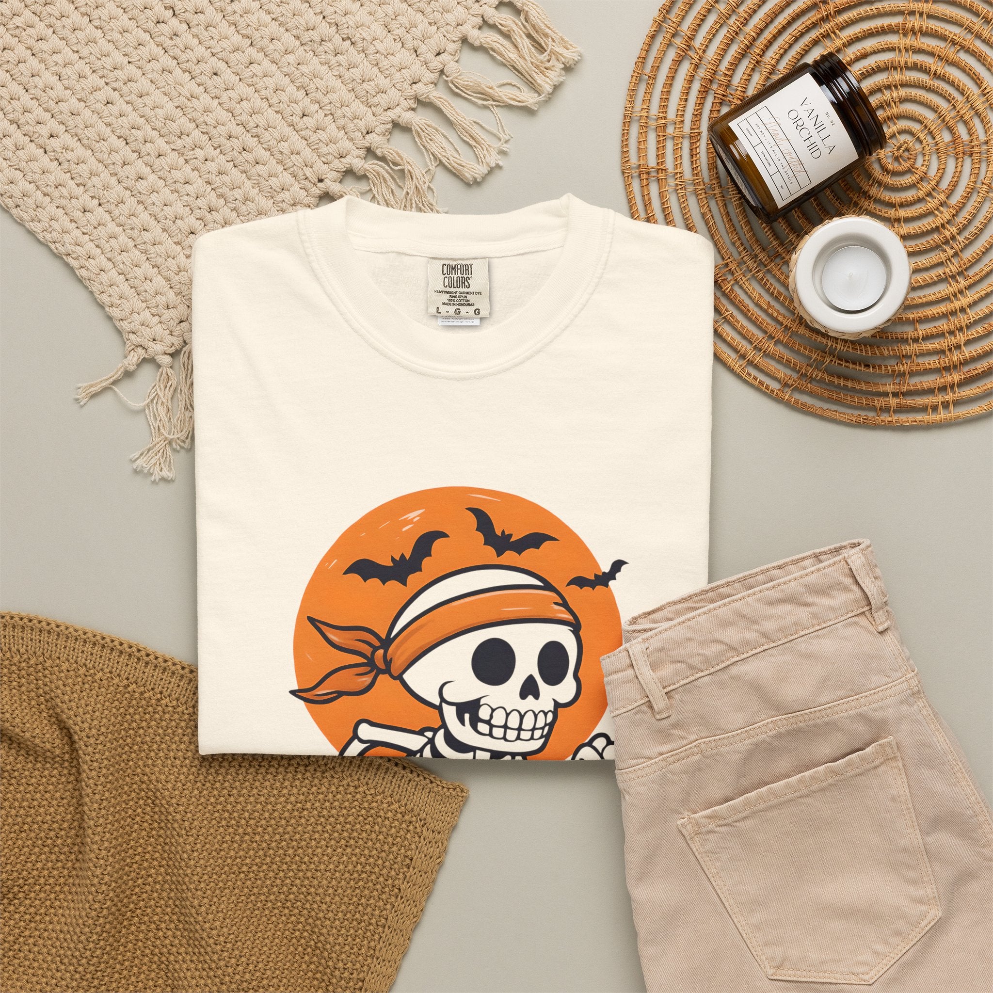 Ivory unisex Halloween T-shirt with skeleton rattle & run print, folded
