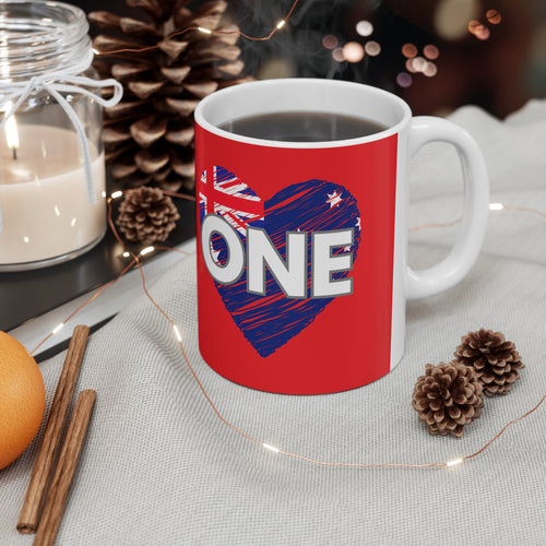 Red ceramic coffee mug with white rim, handle, and blue heart graphic with ONE text