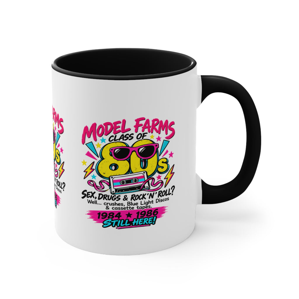 White ceramic mug with black interior and handle, colorful retro cassette graphic