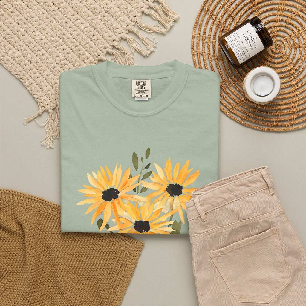 Mint green t-shirt with sunflower bouquet graphic in orange, yellow, and dark accents