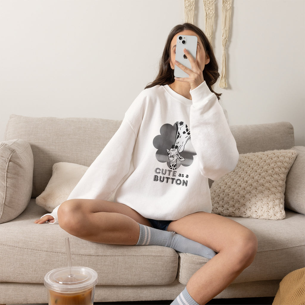 White crewneck sweatshirt with giraffe cloud graphic and "CUTE as a BUTTON" text