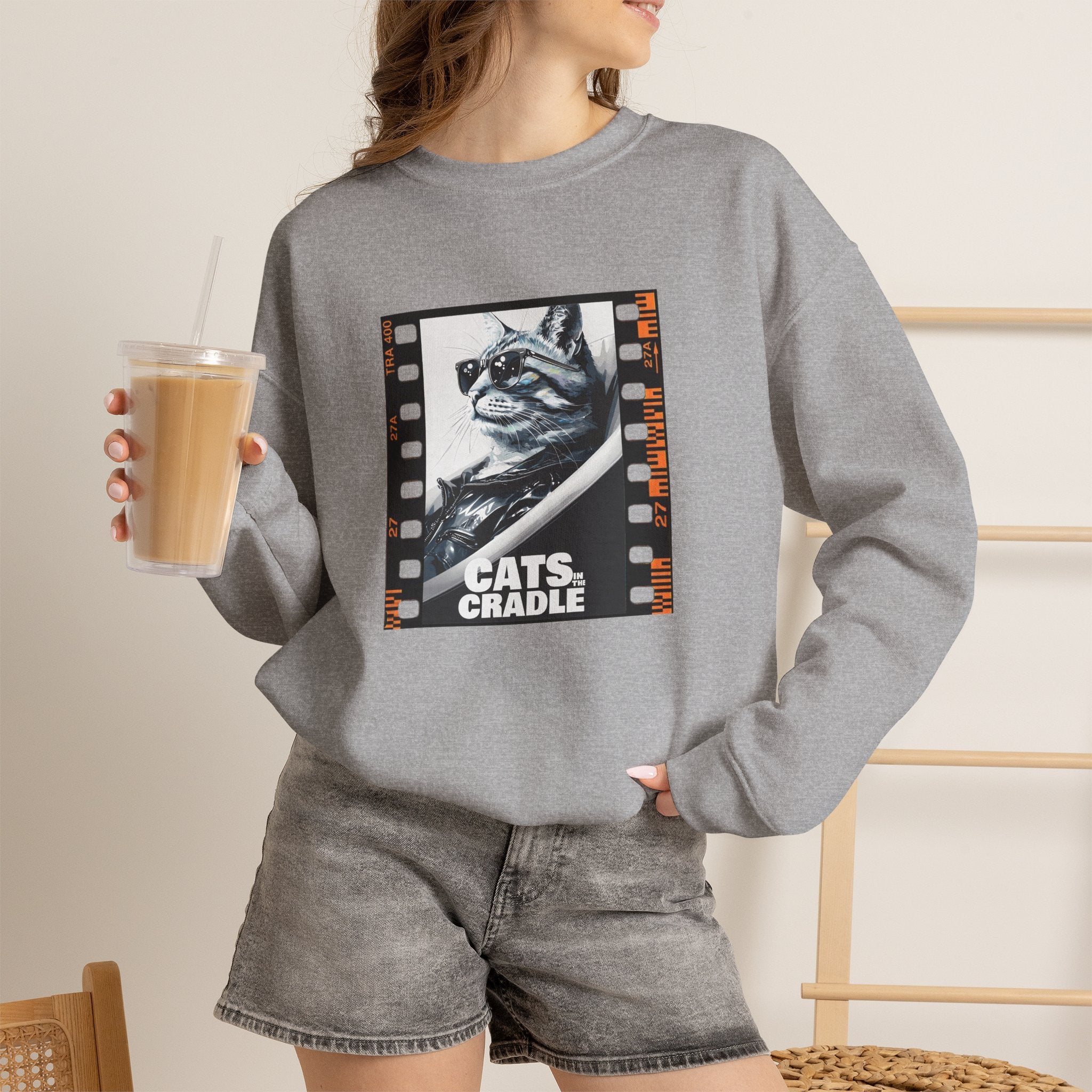 Gray crewneck sweatshirt on model with cat filmstrip graphic on chest