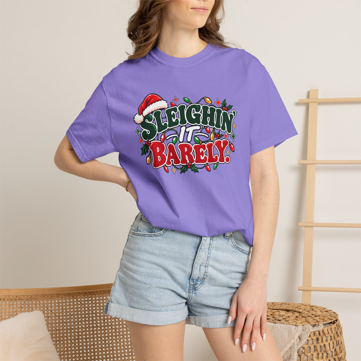 Purple crew-neck t-shirt worn by model, 'Sleighin' It Barely' graphic