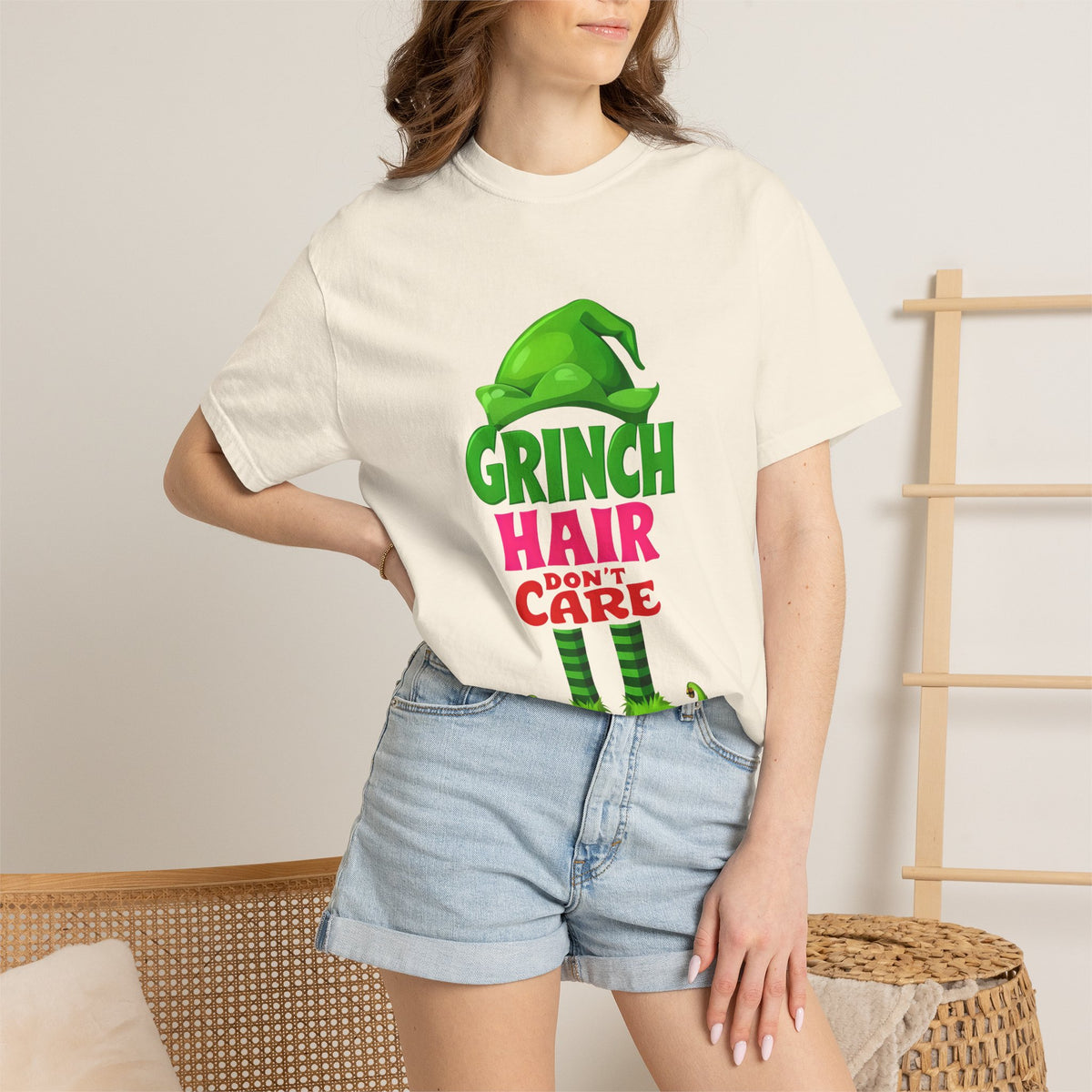 White crew-neck graphic t-shirt with green, pink, and red Grinch hair care print