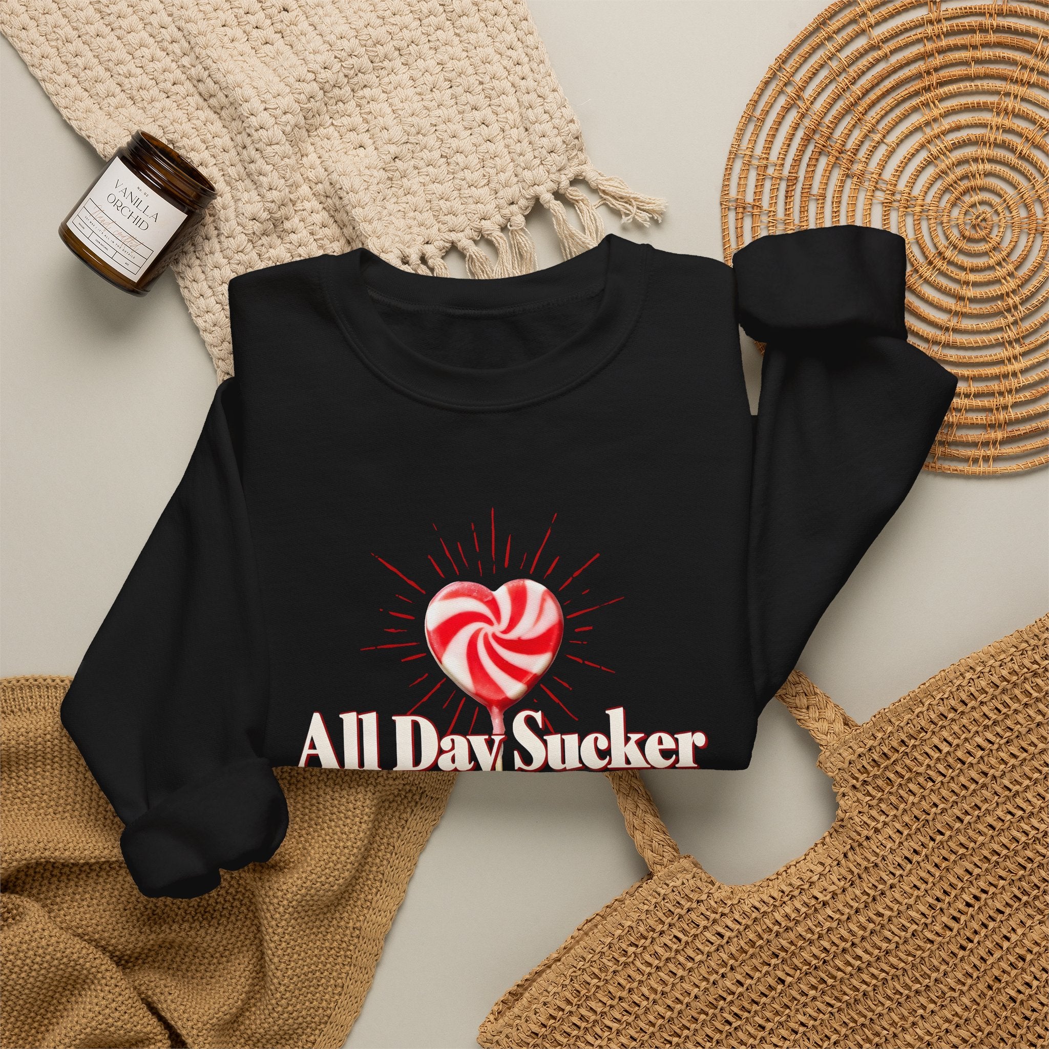 Black sweatshirt laid flat with lollipop heart graphic and "All Day Sucker" text