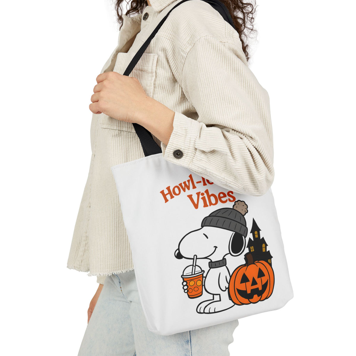 White canvas tote with black handles and 'Howl-loween Vibes' pumpkin graphic