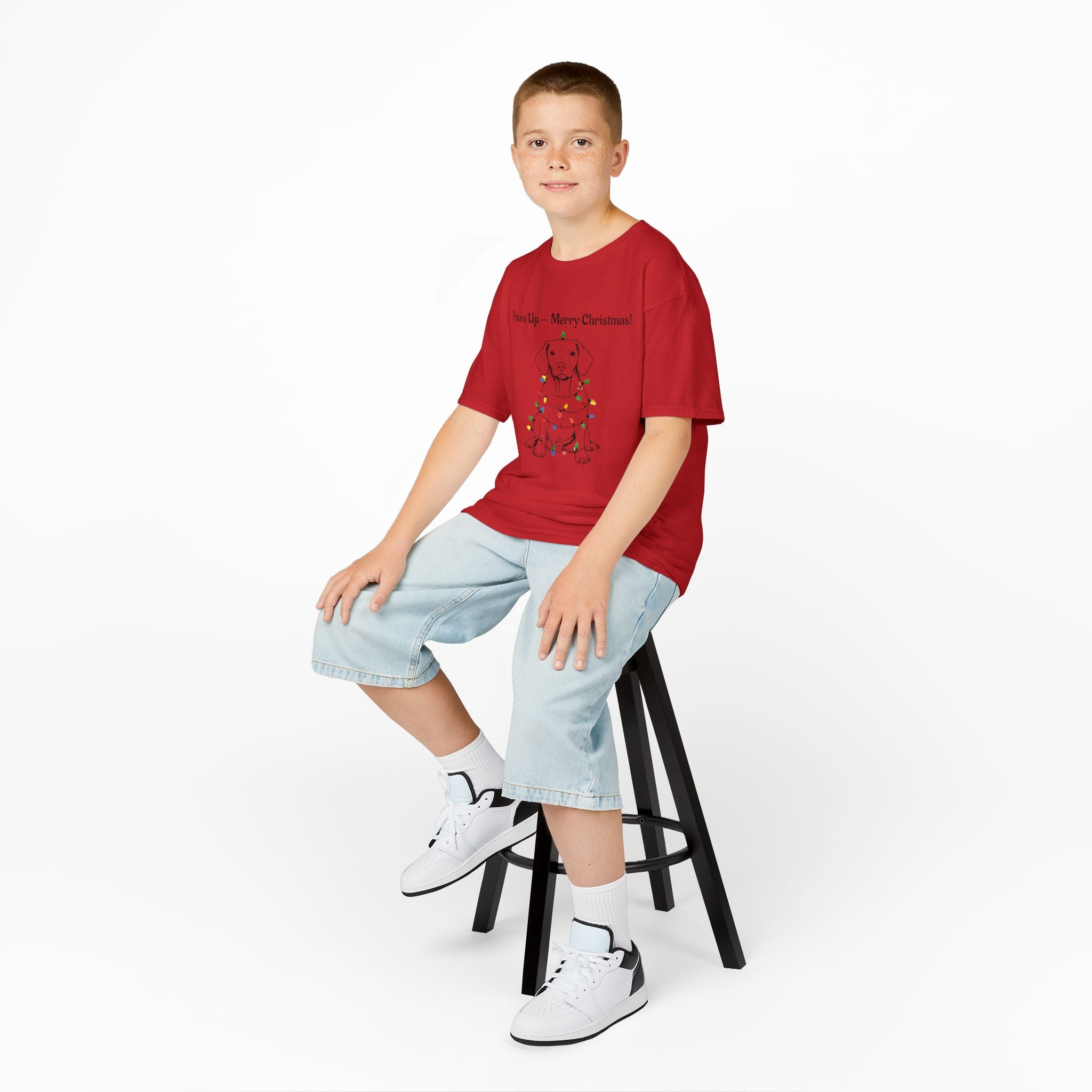 Kids red tee on model with cartoon puppy wearing holiday lights