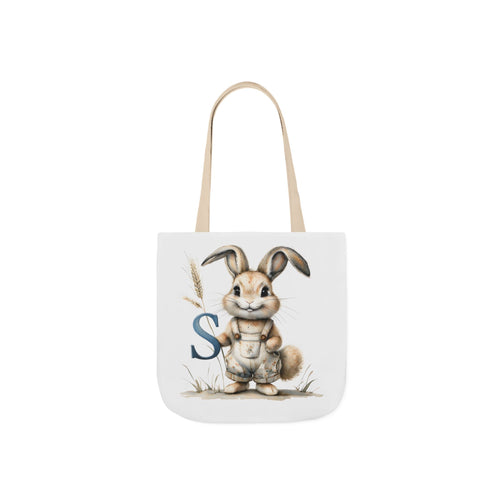 Tote bag with bunny graphic and blue letter S on front, beige handles