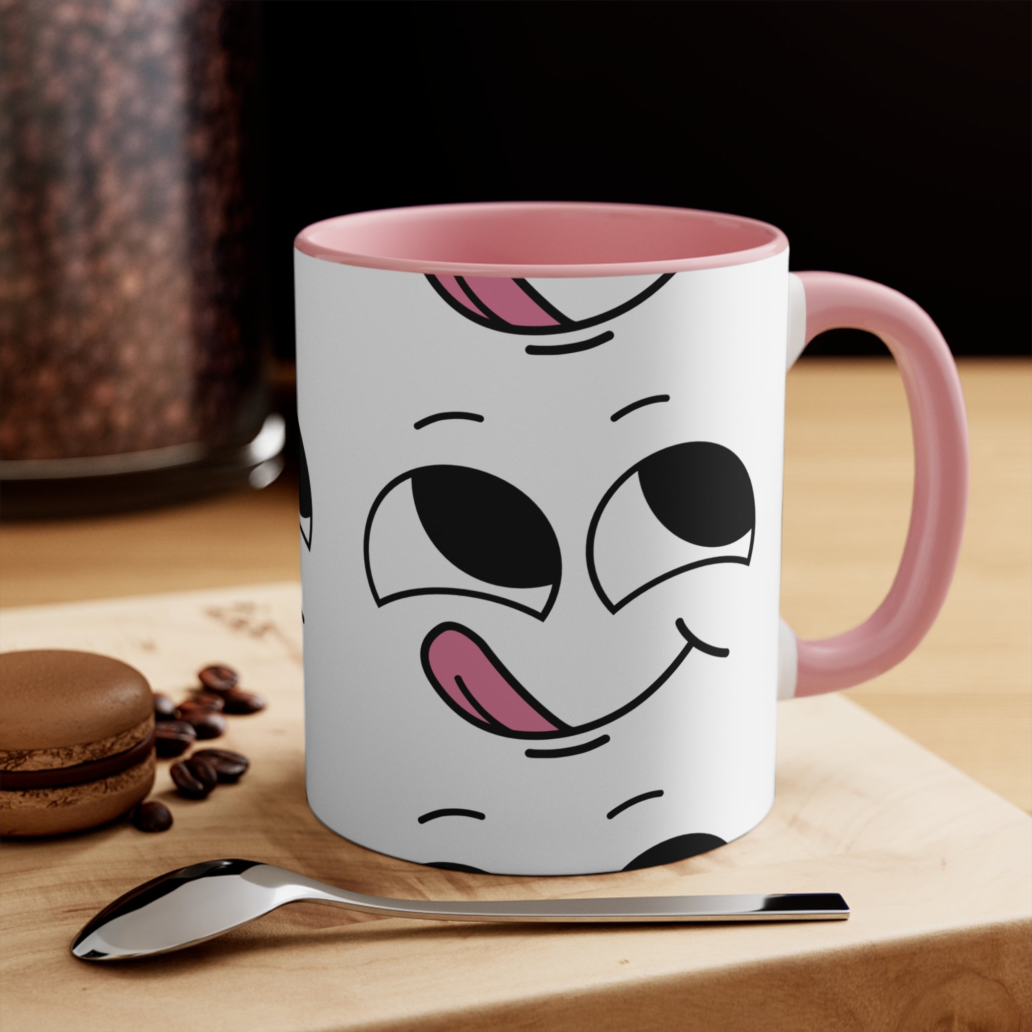 White 11oz mug with pink inside, handle, and tongue-faced outline design