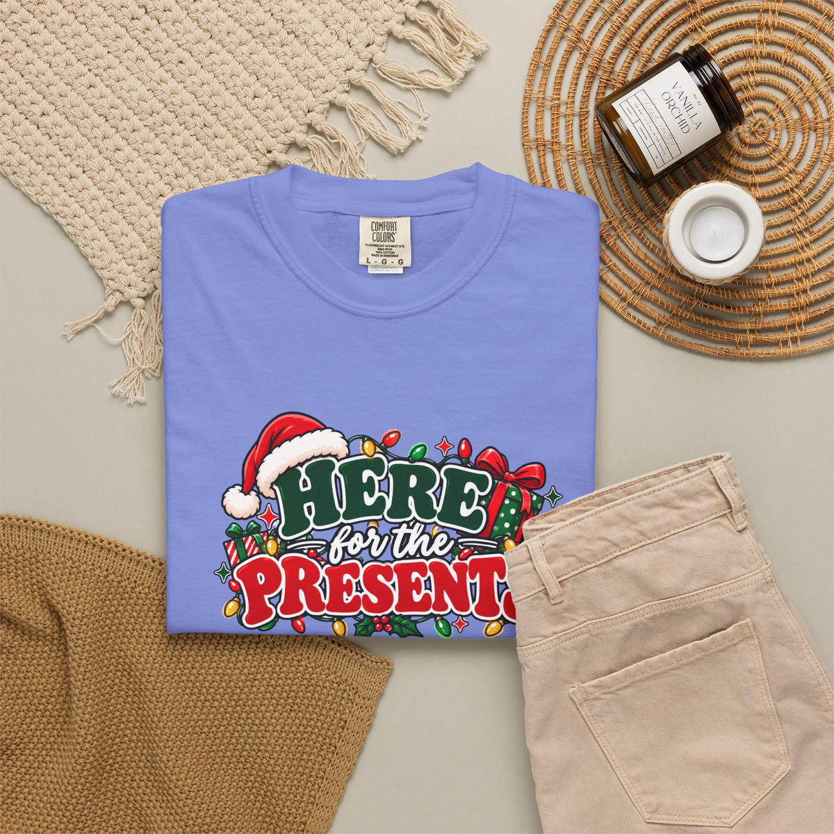 Light blue crew-neck T-shirt featuring the holiday graphic "Here for the Presents"