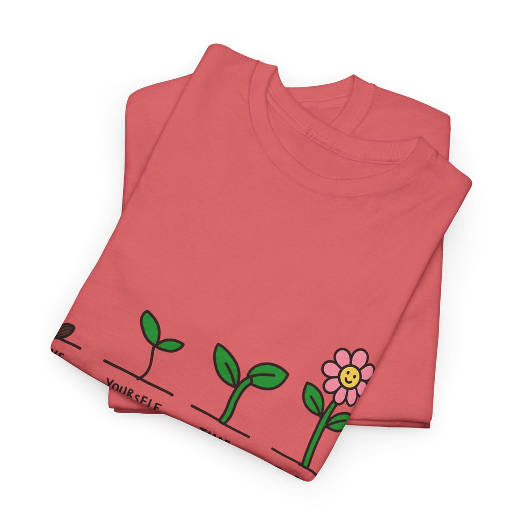 Coral T-shirt with sprout-and-flower growth graphic, folded and laid flat
