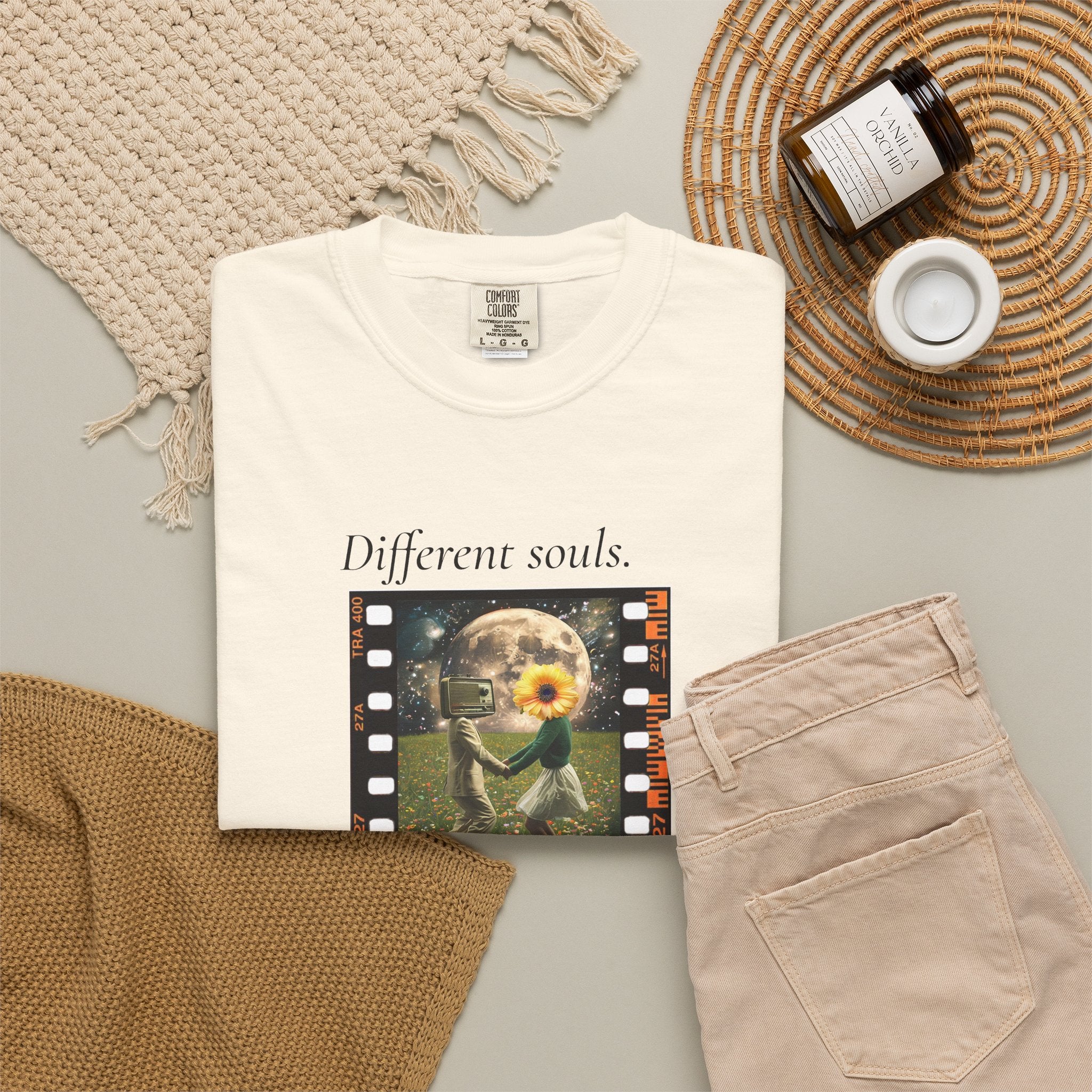 White crew-neck tee flat lay with front 'Different souls' filmstrip graphic