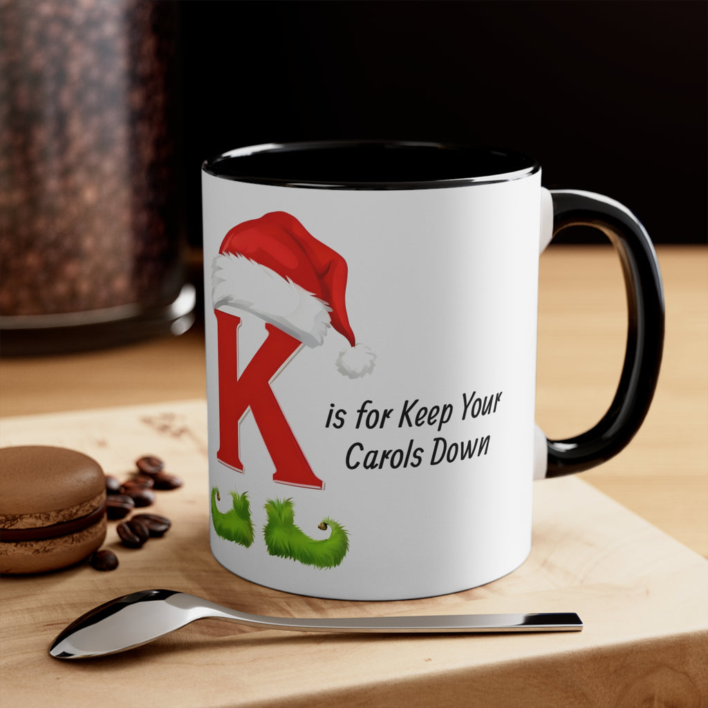 Christmas letter K mug, red hat graphic and 'K is for Keep Your Carols Down' text