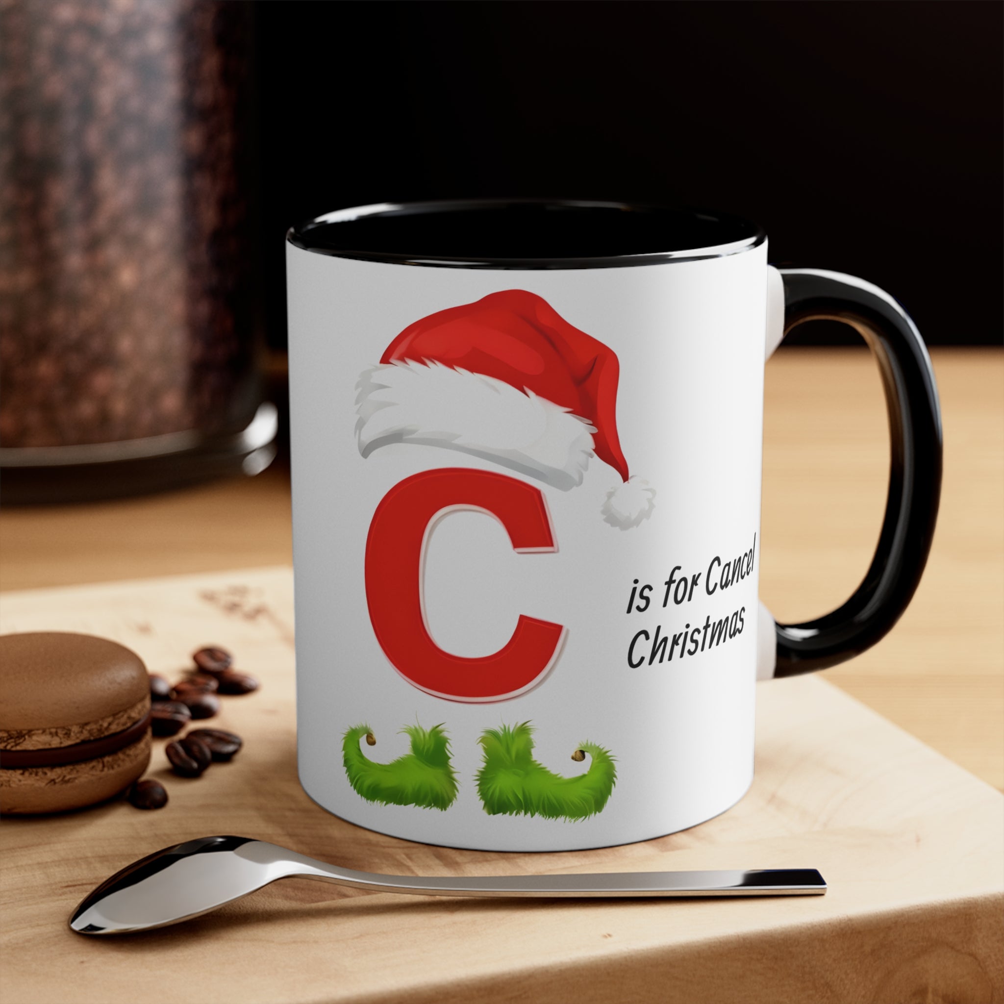 White mug with black interior/handle; centered C Santa hat design, “is for Cancel Christmas”