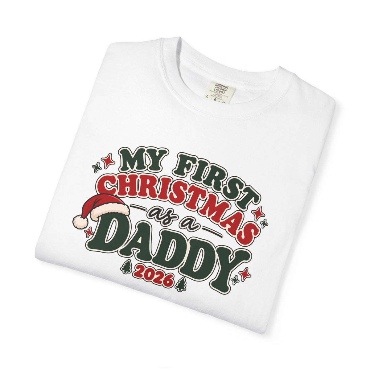 White short-sleeve T-shirt with colorful holiday text graphic: “First Christmas as a Daddy 2026”