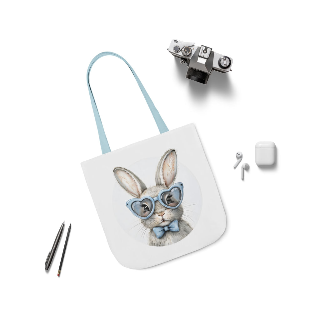 Bunny canvas tote bag with rabbit face graphic, light blue straps laid flat