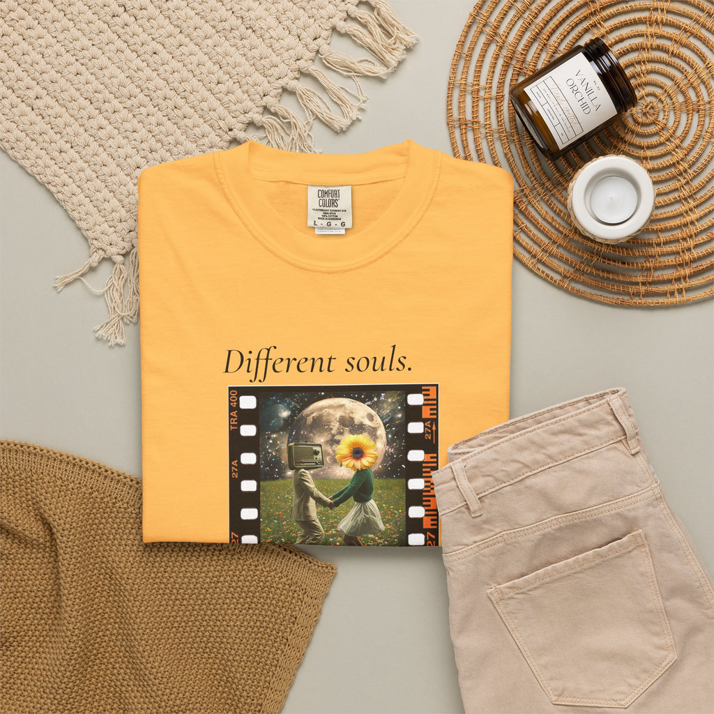 Orange crew-neck tee flat lay with front 'Different souls' filmstrip graphic