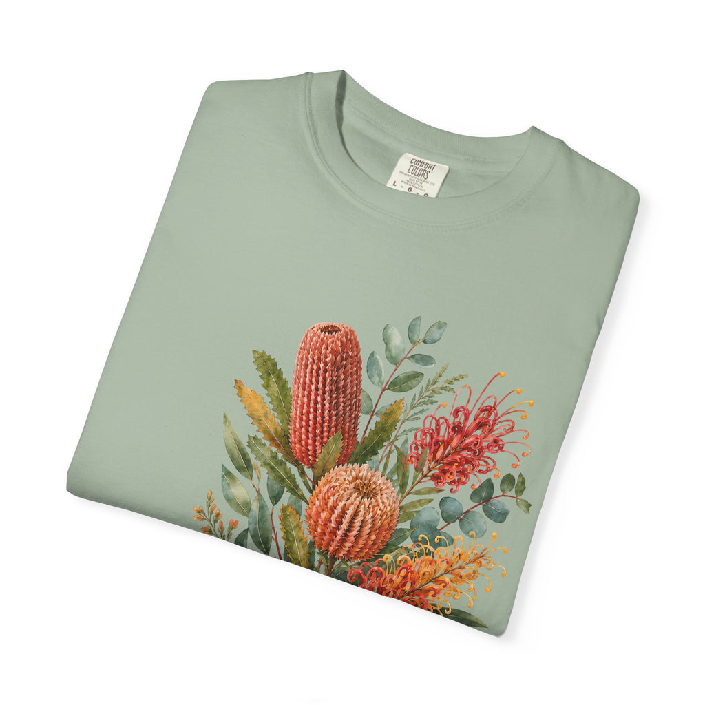 Sage green T-shirt with colorful protea bouquet graphic across the front