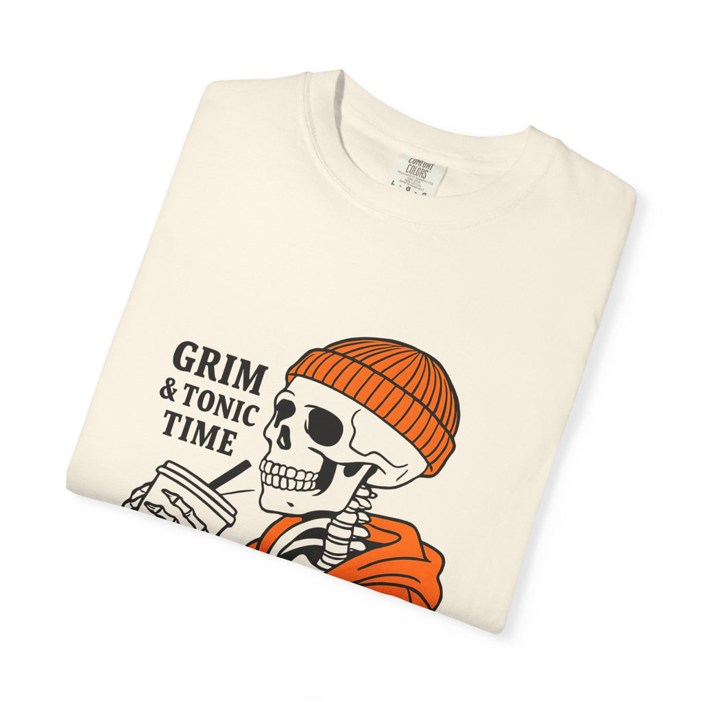 Ivory graphic tee with Grim & Tonic Time skull, orange beanie, and orange jacket print