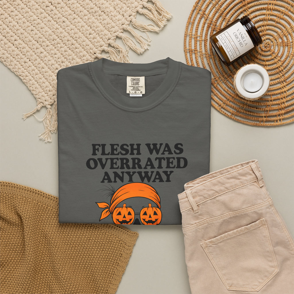Dark gray Halloween graphic unisex tee shown folded with orange jack-o-lantern skull print