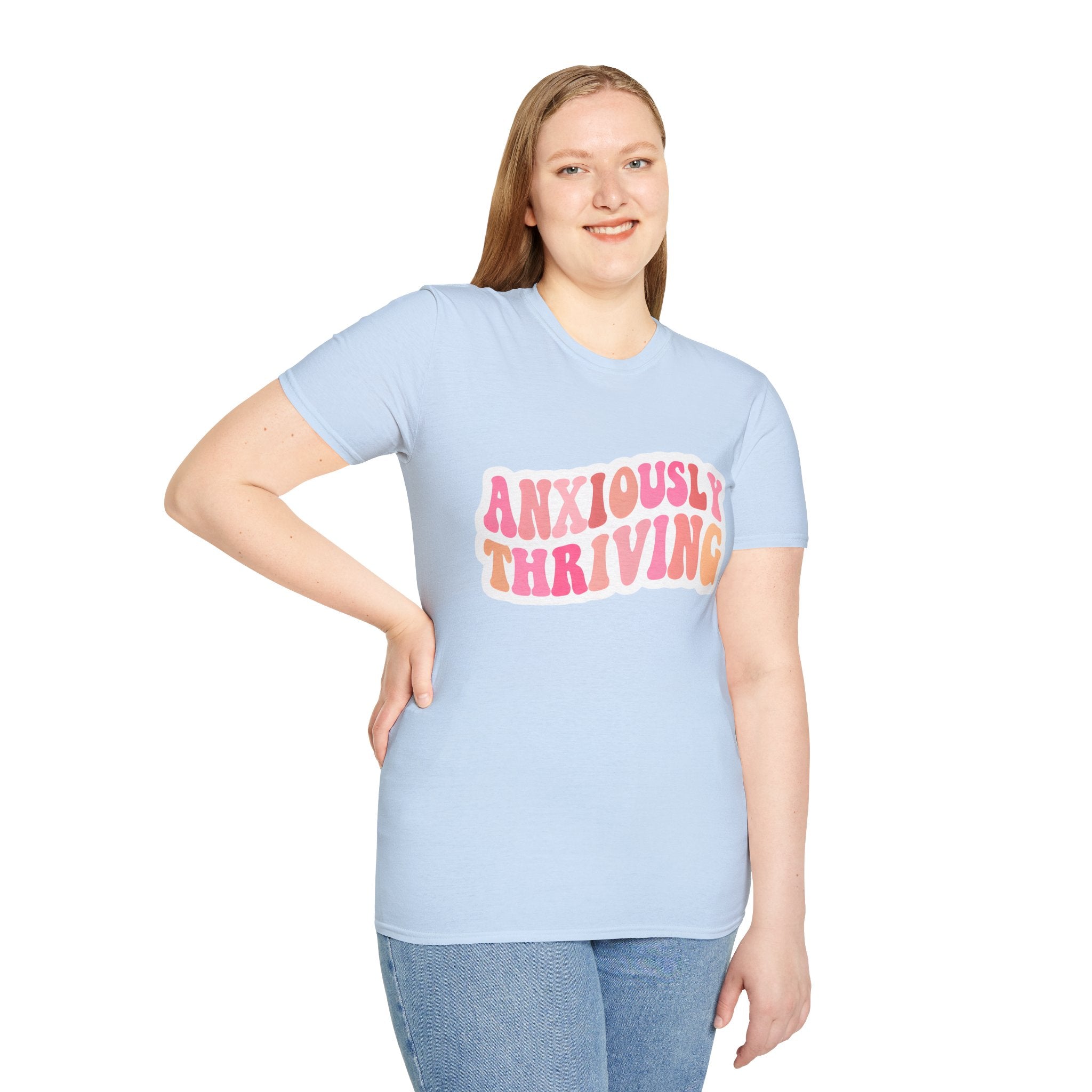 Unisex softstyle t-shirt light blue on model with “ANXIOUSLY THRIVING” chest print
