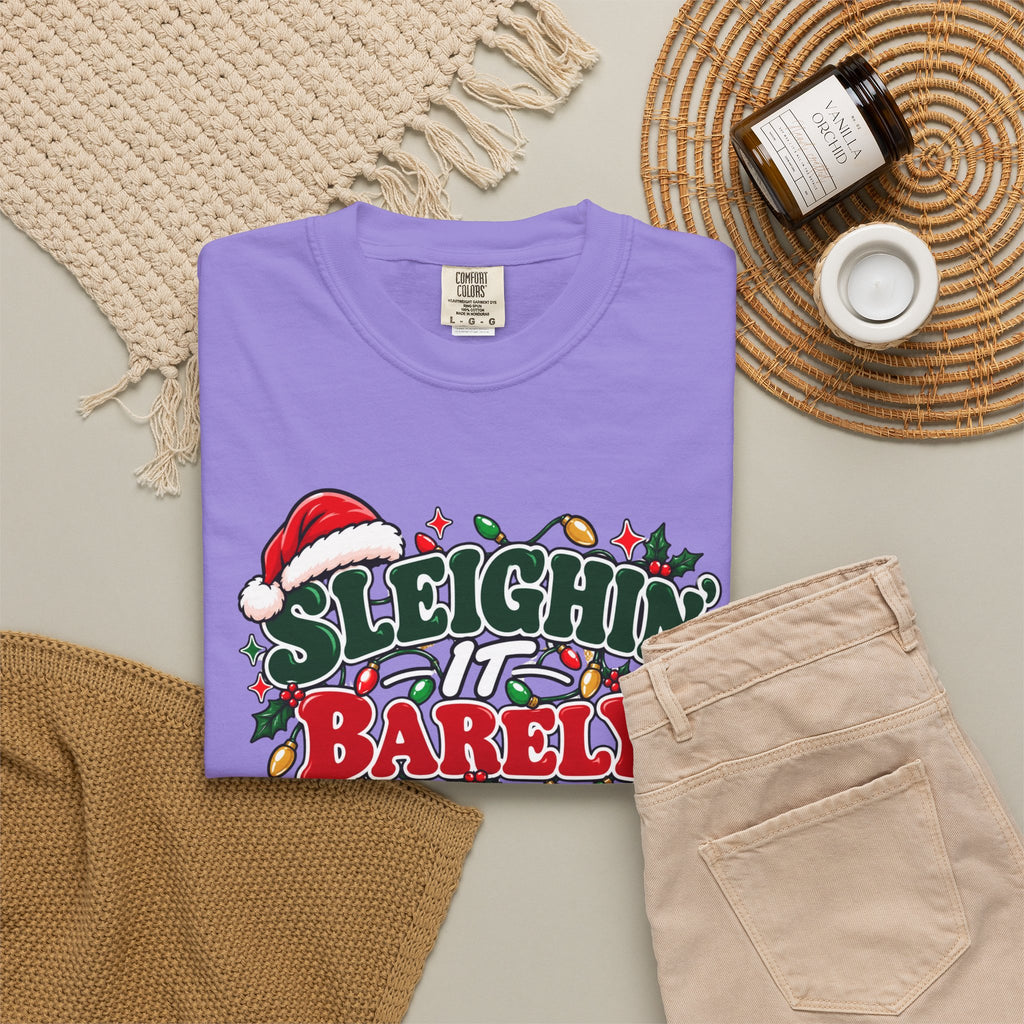 Purple crew-neck t-shirt with 'Sleighin' It Barely' holiday slogan graphic