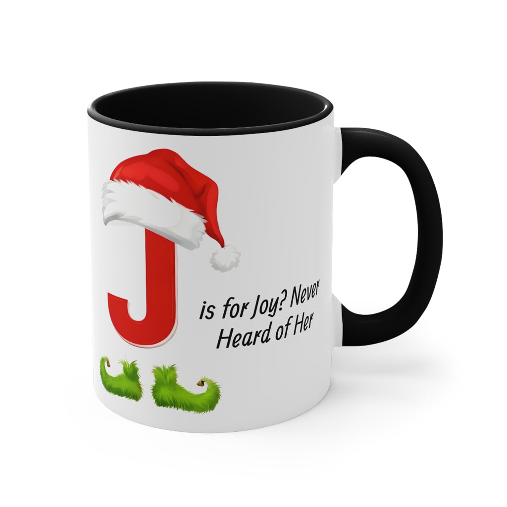 White mug with black handle, red letter J with Santa hat and green boots on front