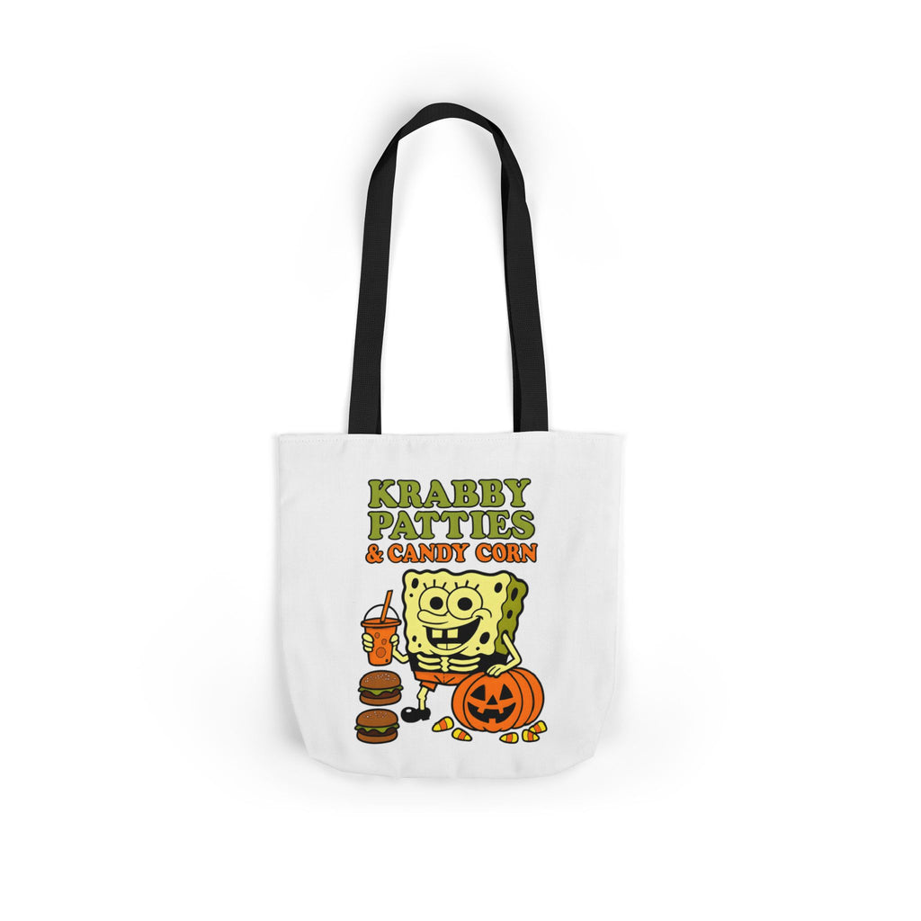 White canvas tote bag with black handles, featuring centered Krabby Patties & candy corn artwork