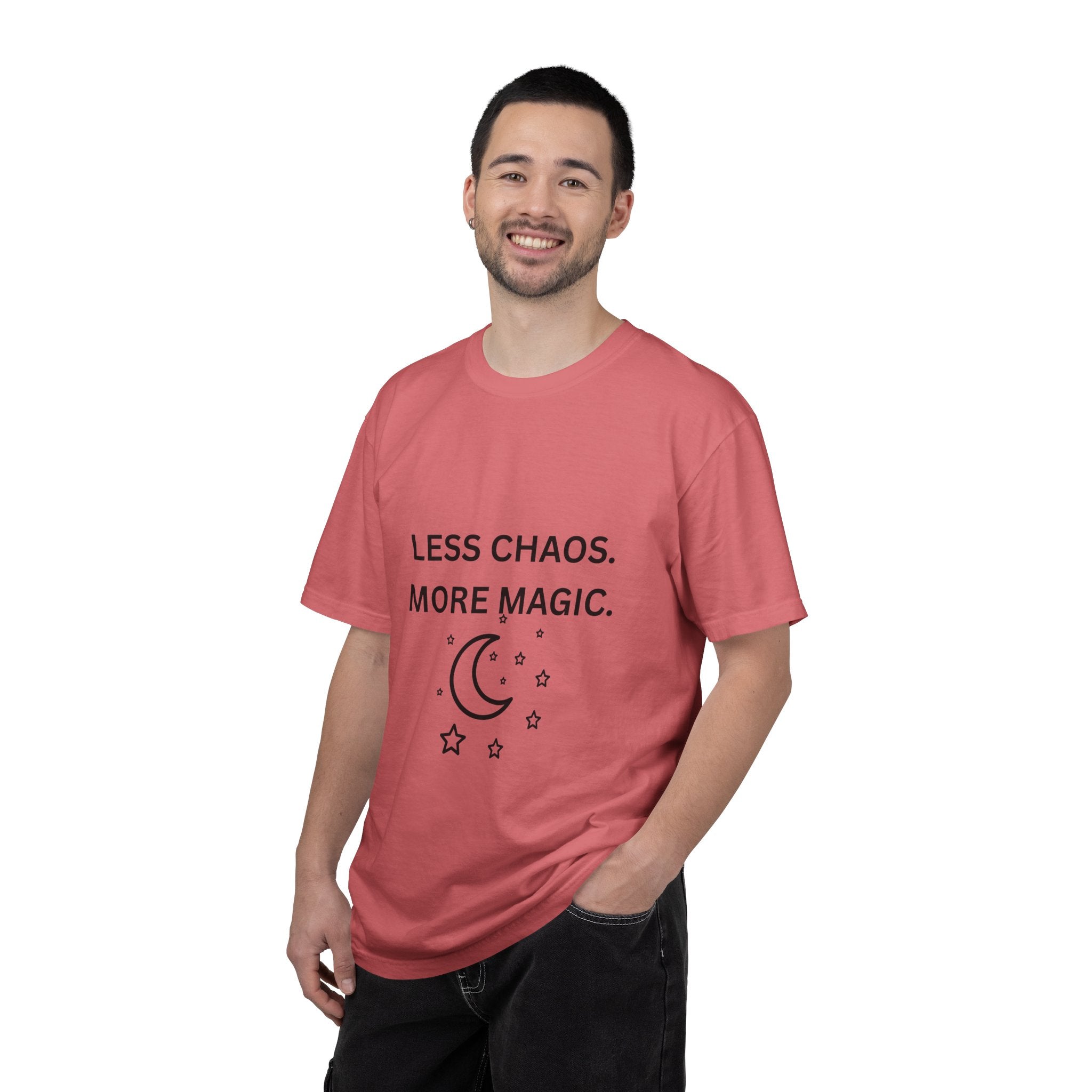Pink crewneck T-shirt worn by a man; “Less Chaos, More Magic” with moon and stars