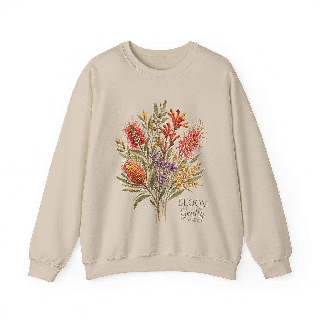 Beige crewneck sweatshirt with colorful floral bouquet graphic and “BLOOM Gently” text.