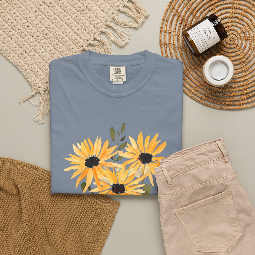 Blue crew-neck T-shirt with orange sunflower bouquet print and green leaves