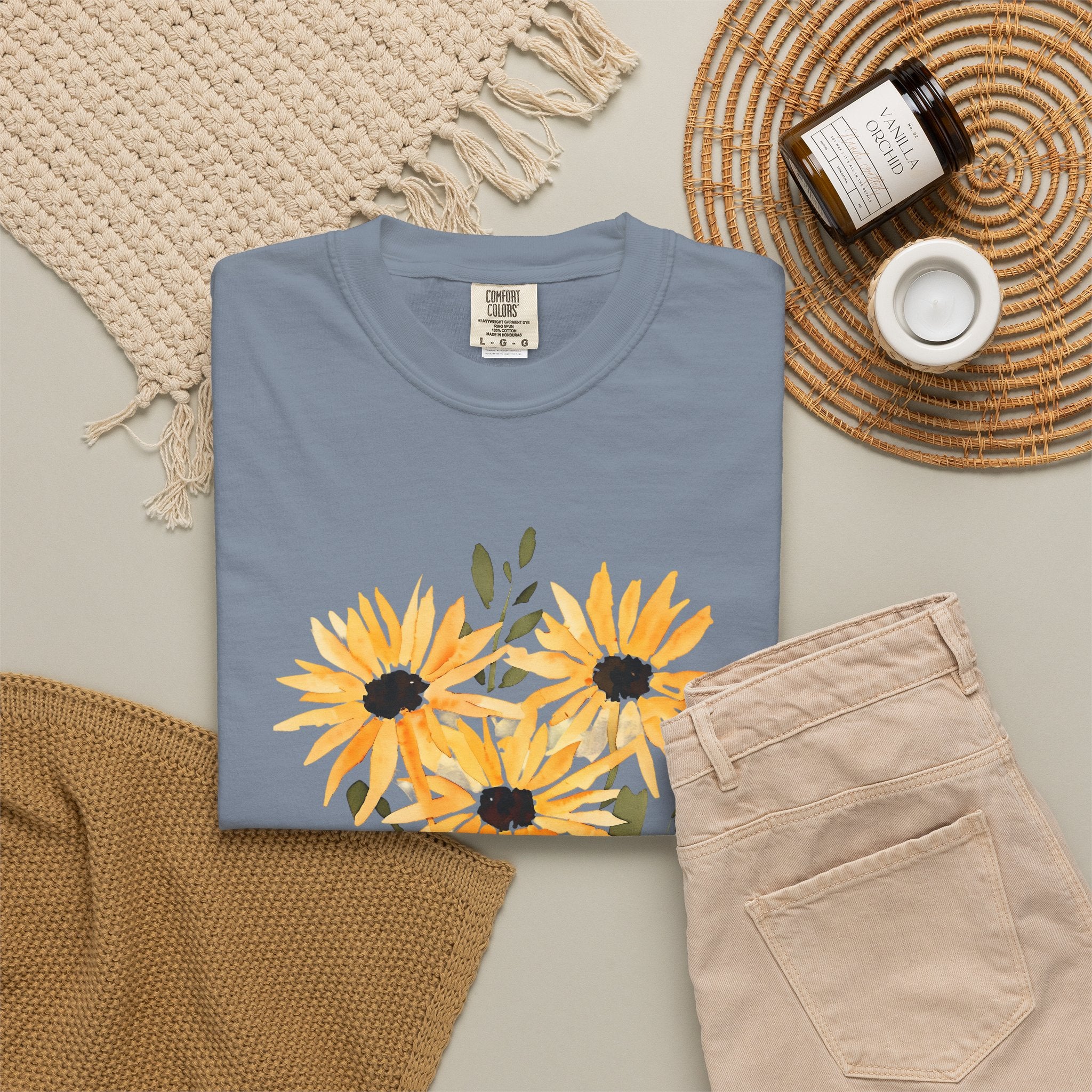 Blue crew-neck T-shirt with orange sunflower bouquet print and green leaves