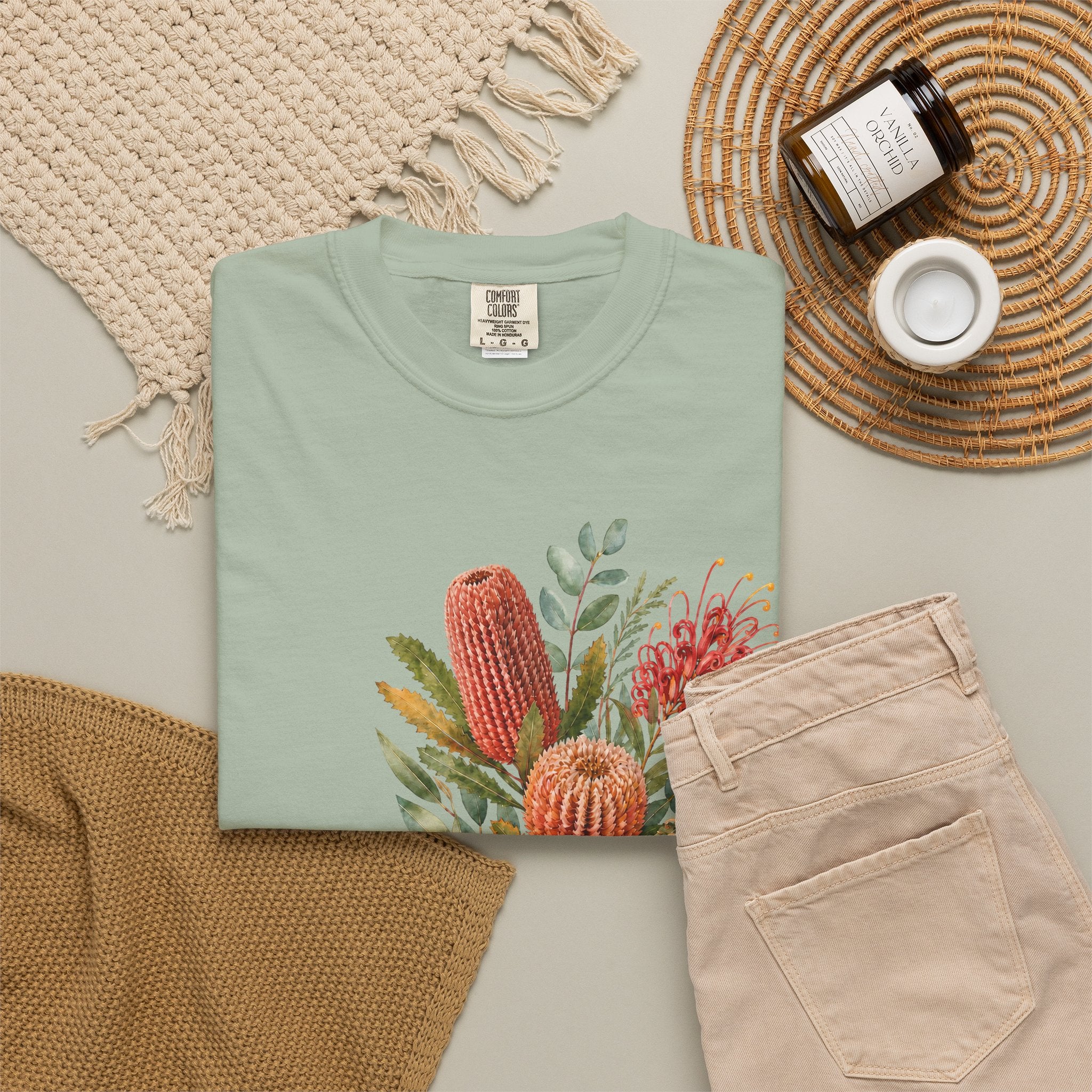Light green T-shirt with colorful protea bouquet graphic on the front