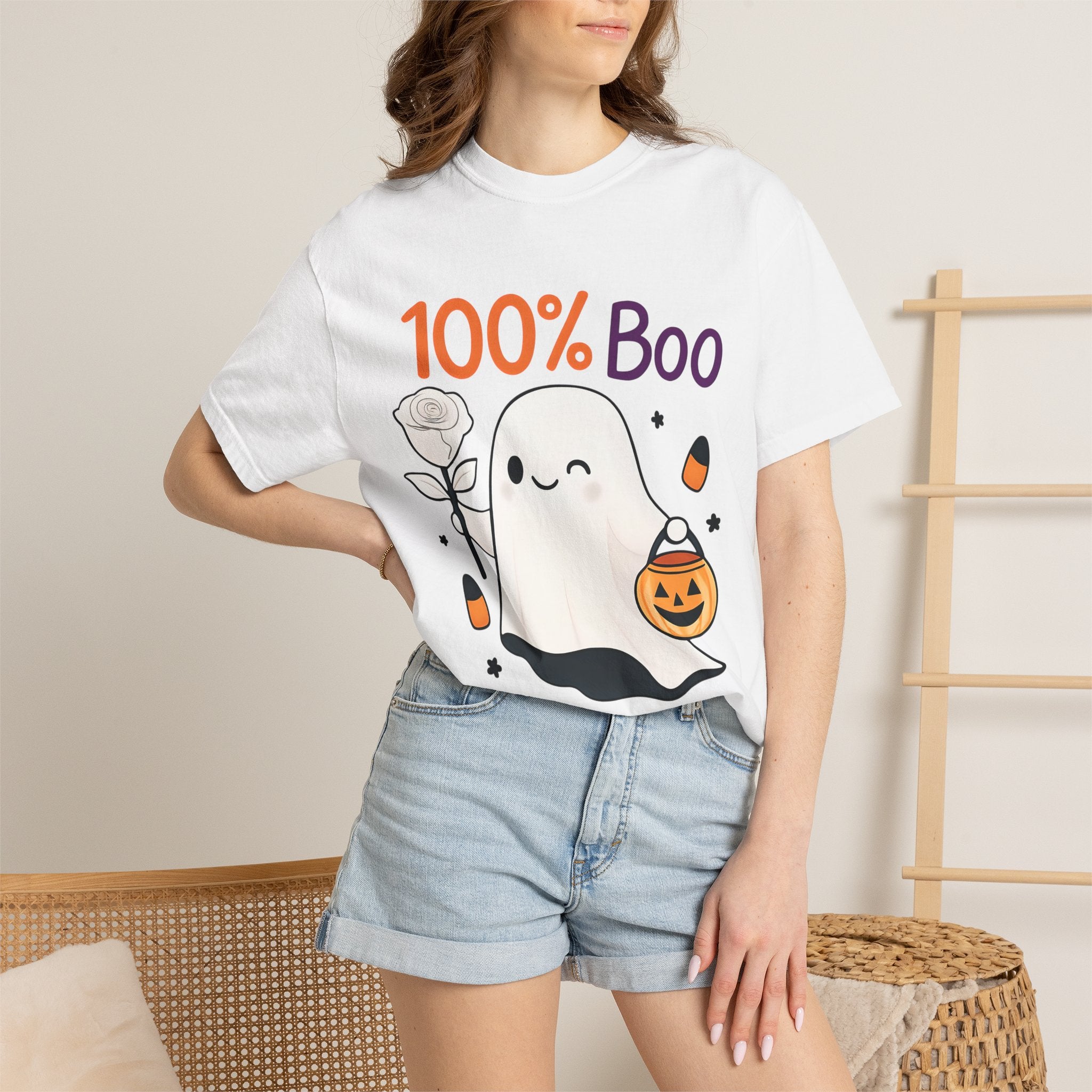 White Halloween graphic t-shirt worn by model, “100% Boo” ghost and pumpkin