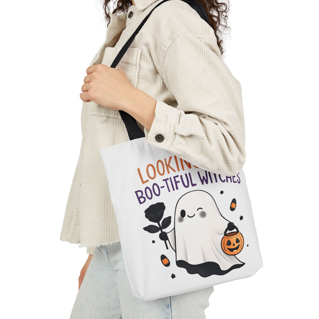 White canvas tote bag with black handles; ghost and jack-o'-lantern print