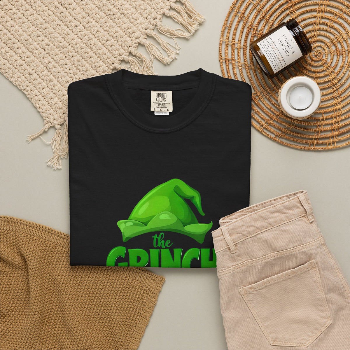 Black unisex graphic T-shirt with Grinch “Made Me Do It” front print, laid flat