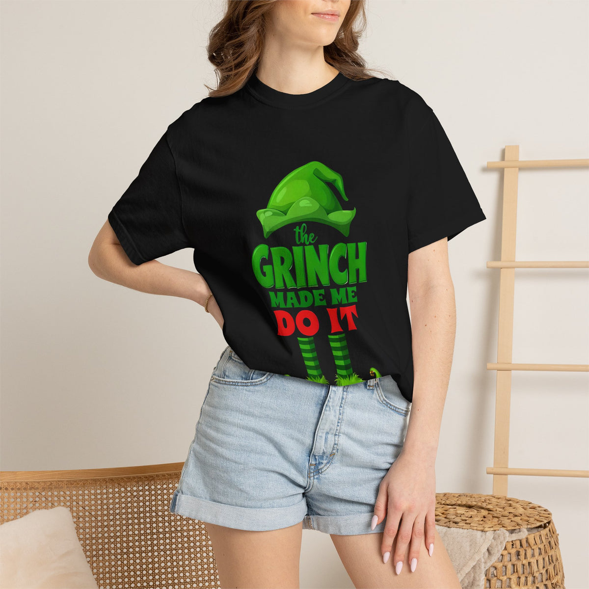 Black unisex graphic T-shirt with Grinch “Made Me Do It” front print on model