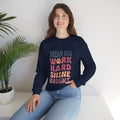 Navy crewneck sweatshirt with colorful motivational paw-print graphic on chest