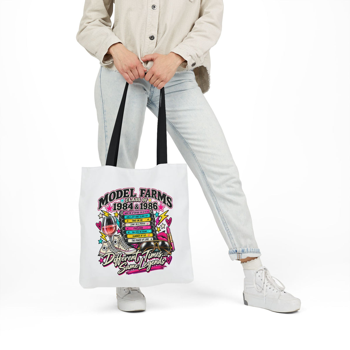 White canvas tote bag with black handles and colorful Model Farms 1984–1986 graphic.